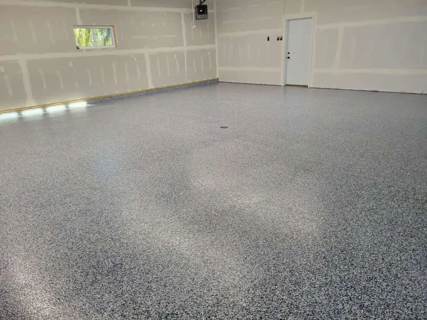 Blue-gray epoxy flake floor in a newly finished residential garage